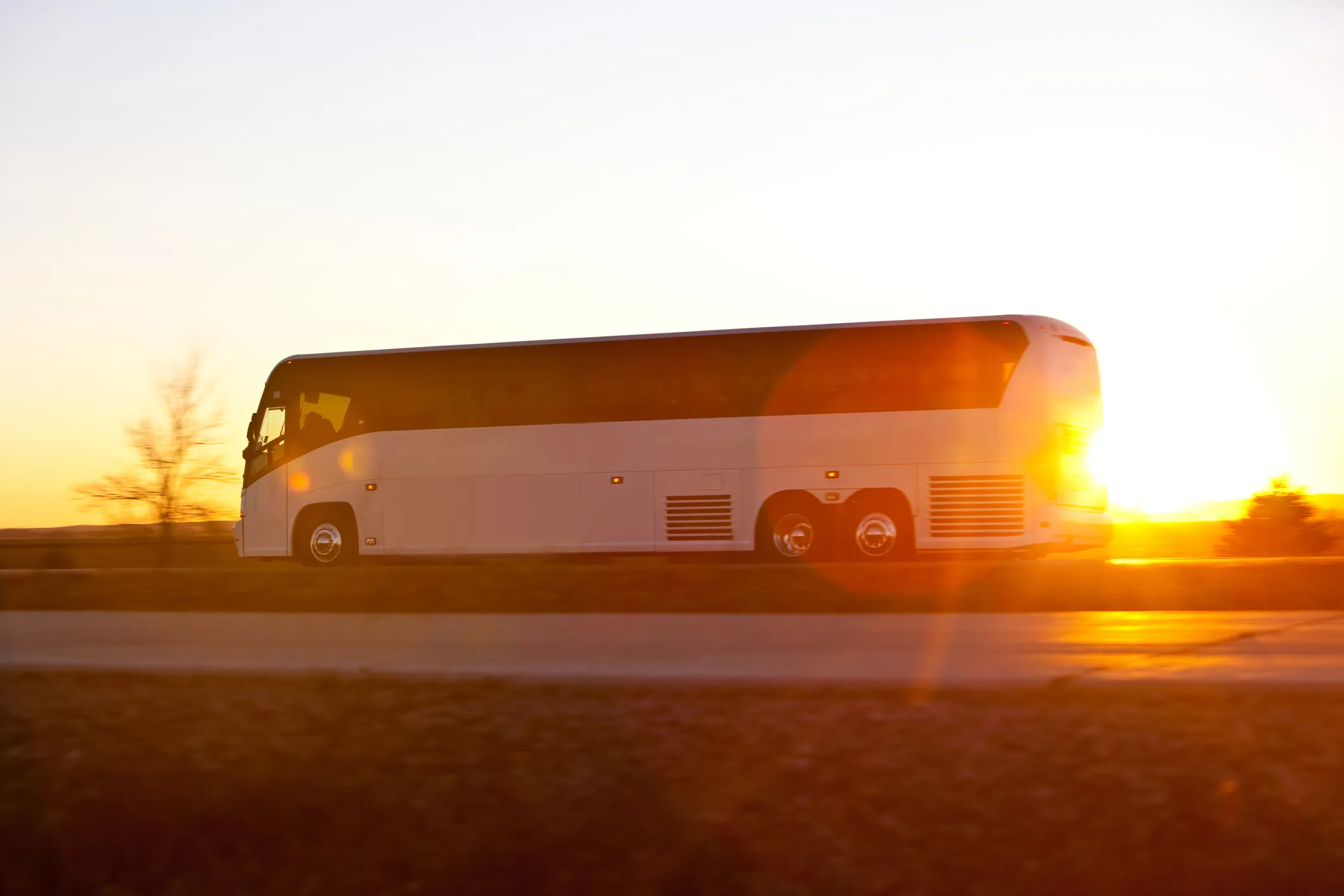 Bus on the highway at sunrise